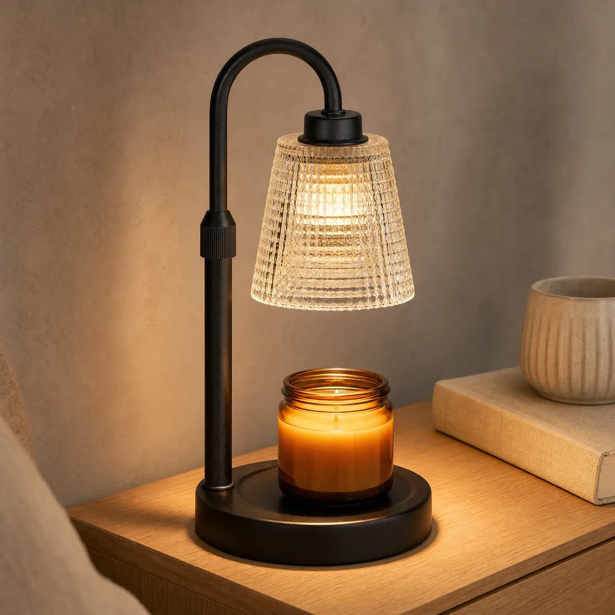 Arc Candle Warmer Lamp (Black / Clear Ribbed) on a nightstand